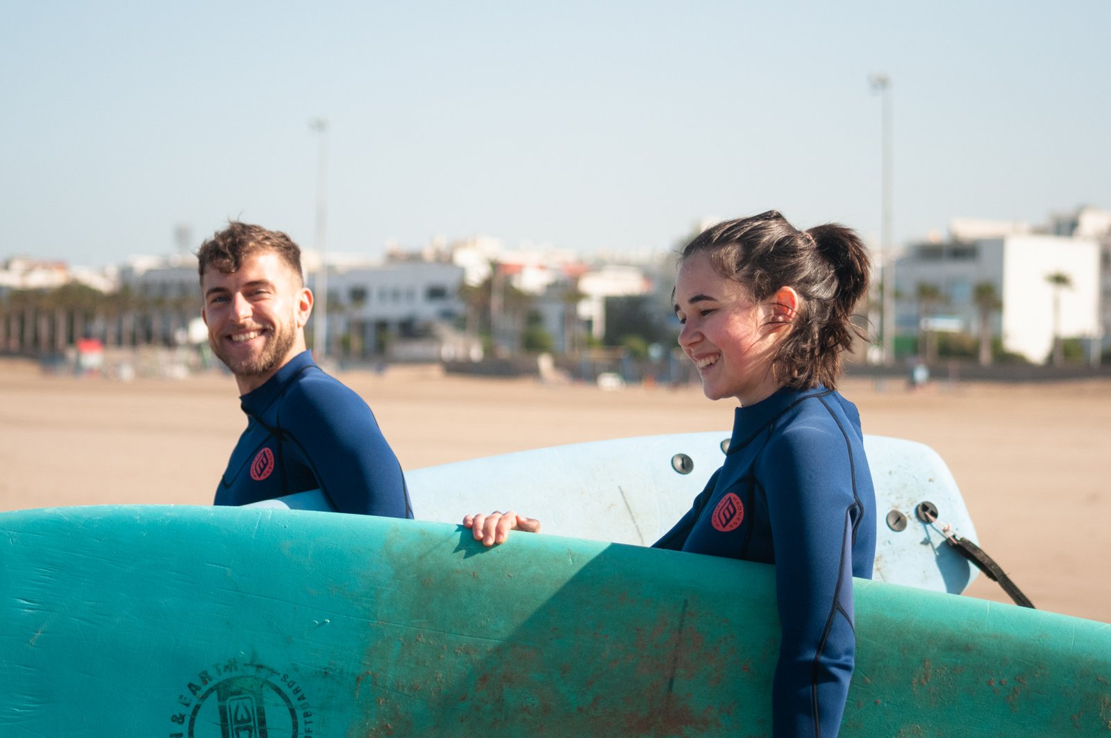 Couple smiling and excited to Strat their surf lesson with Loving Surf in Essaouira