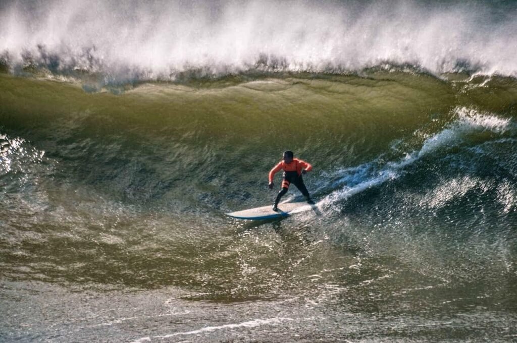 Surfer Soufain taking barrel wave in sidi kabuki Morocco. Photo by Susan Paige Photography