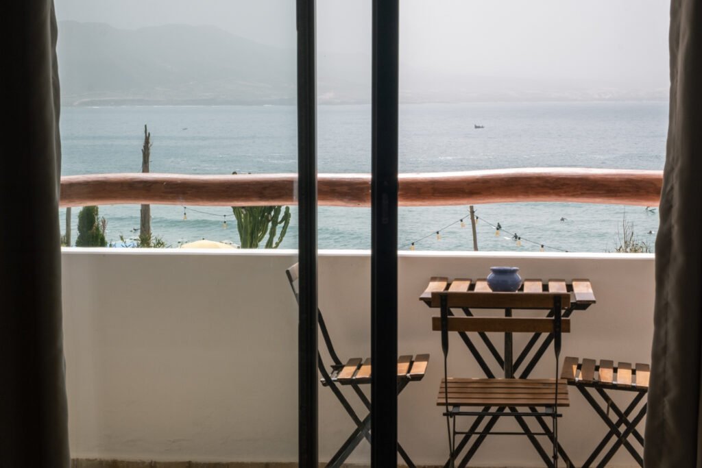 Surfers waiting for set with the Ocean View from Balcony in Jardin Room at Olo Surf & Nature in Imsoaune Morocco