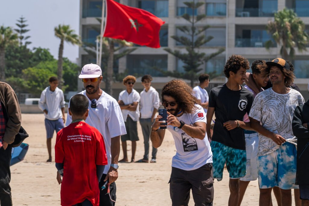 soulymane being interviewed for video being taken of soulymane from Kite Maroc on kitesurf competition at Essaouira beach in Morocco