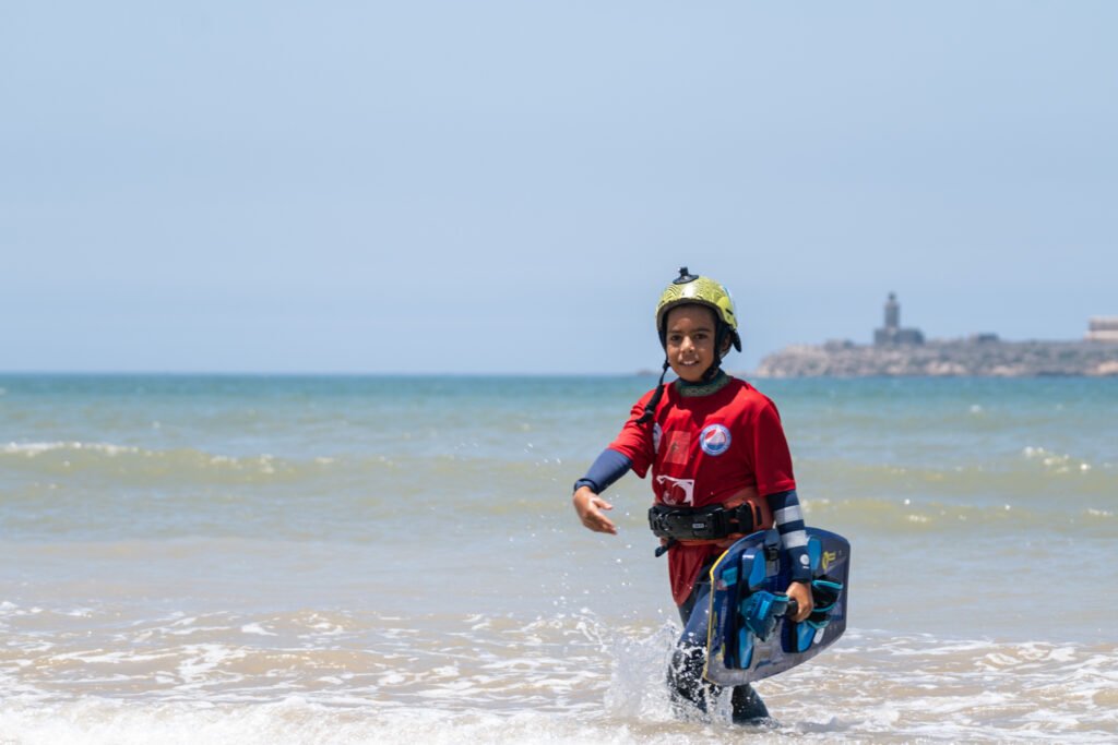 asma, soulymane and medhi from Kite Maroc at kitesurf competition at Essaouira beach in Morocco for association juene essaouira sports nautique