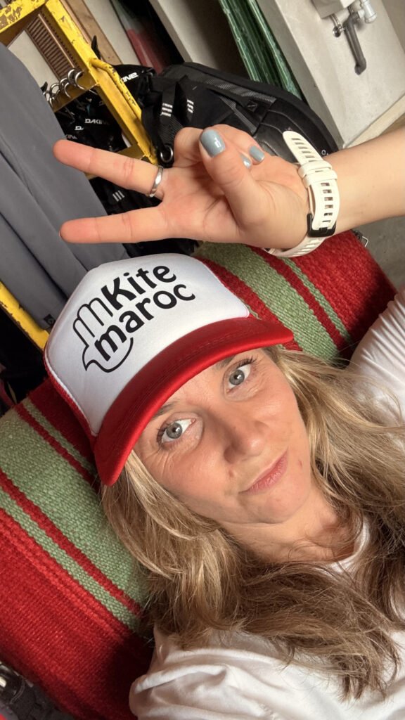 susan marketing agency owner at Kite Maroc in essaouira wearing a red Kite Maroc hat